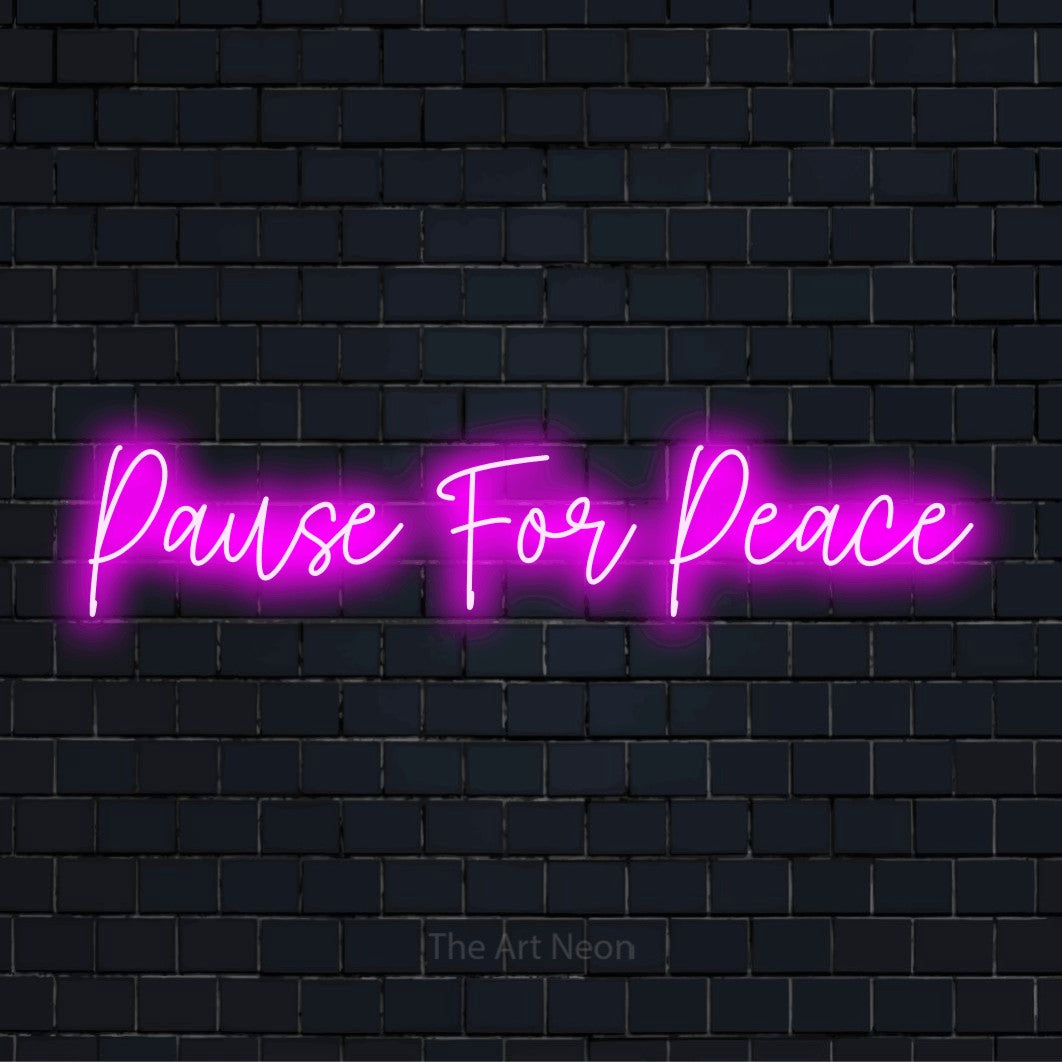 "Pause For Peace" neon text design on a black brick wall