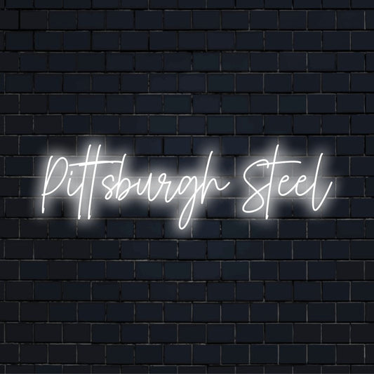 Pittsburgh Steel Neon Light with bright neon lettering on dark brick wall