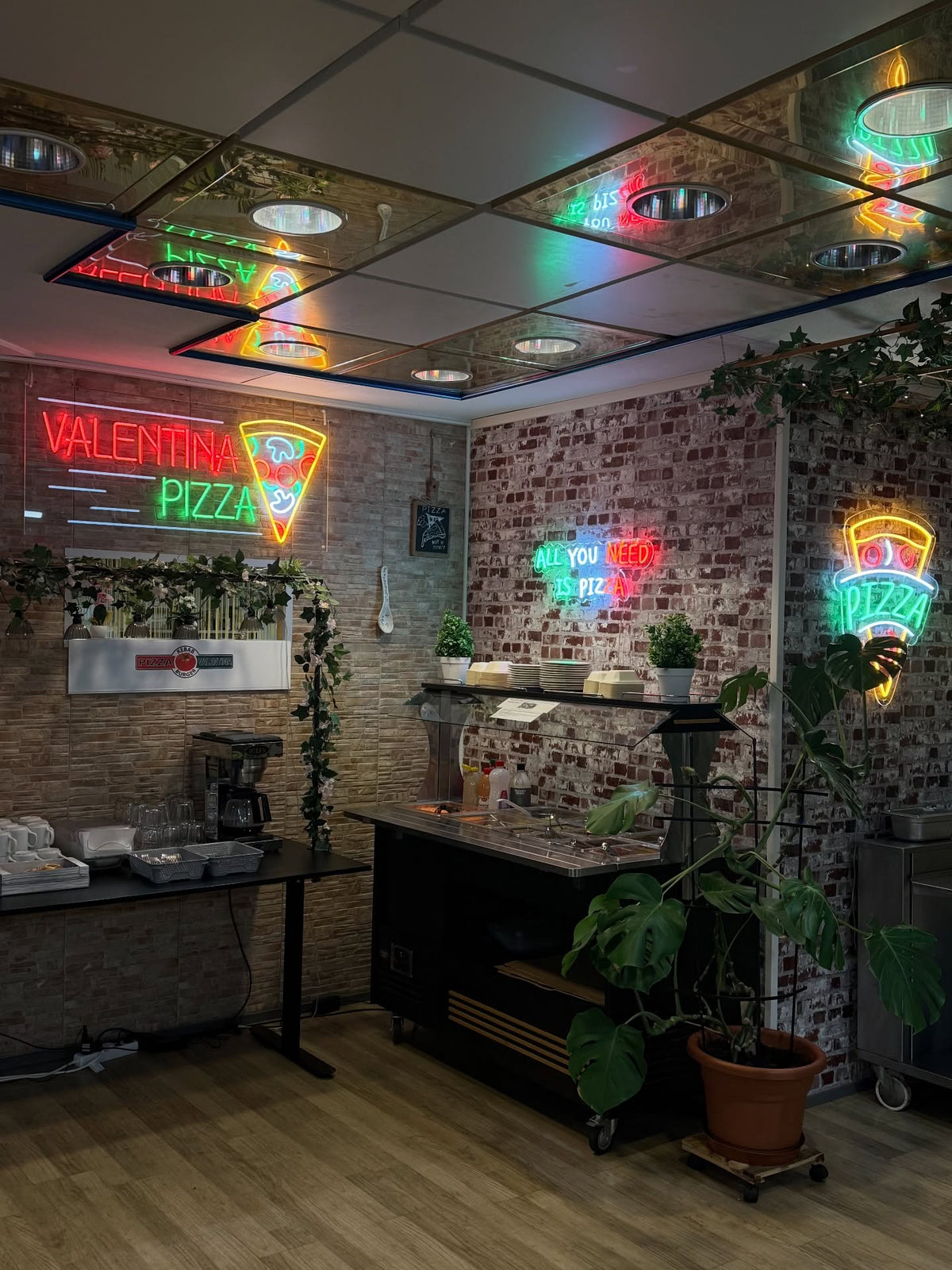 Pizza and burger LED neon designs displayed in a restaurant