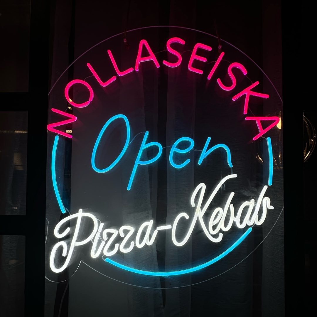OPEN LED neon sign displayed in a restaurant storefront window