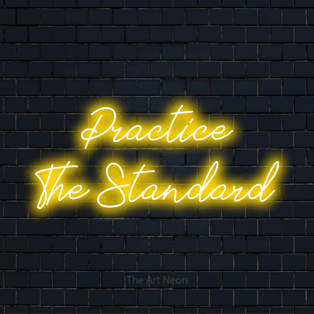"Practice The Standard" glowing LED neon sign on a black brick wall