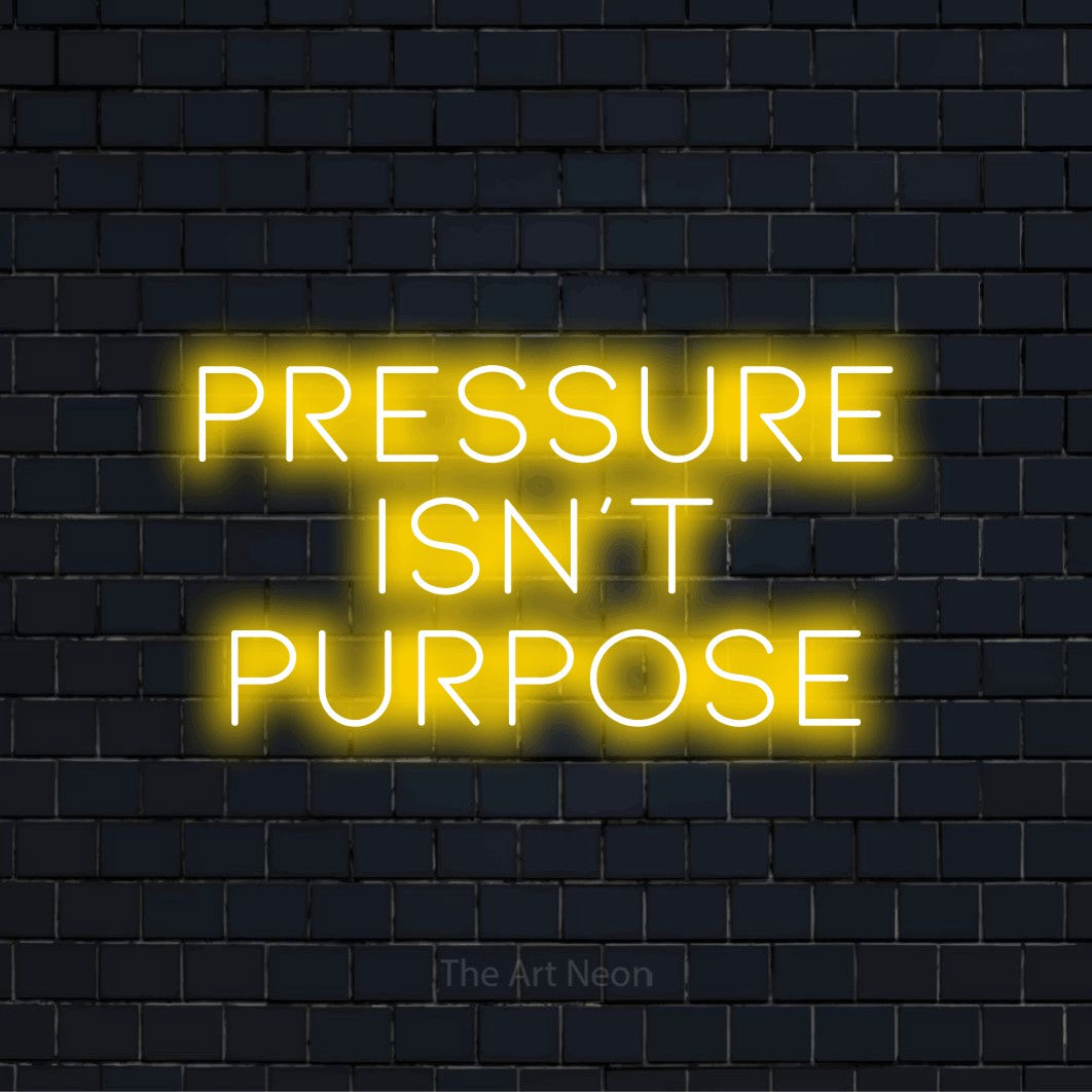 "Pressure Isn’t Purpose" LED neon sign on a black brick wall