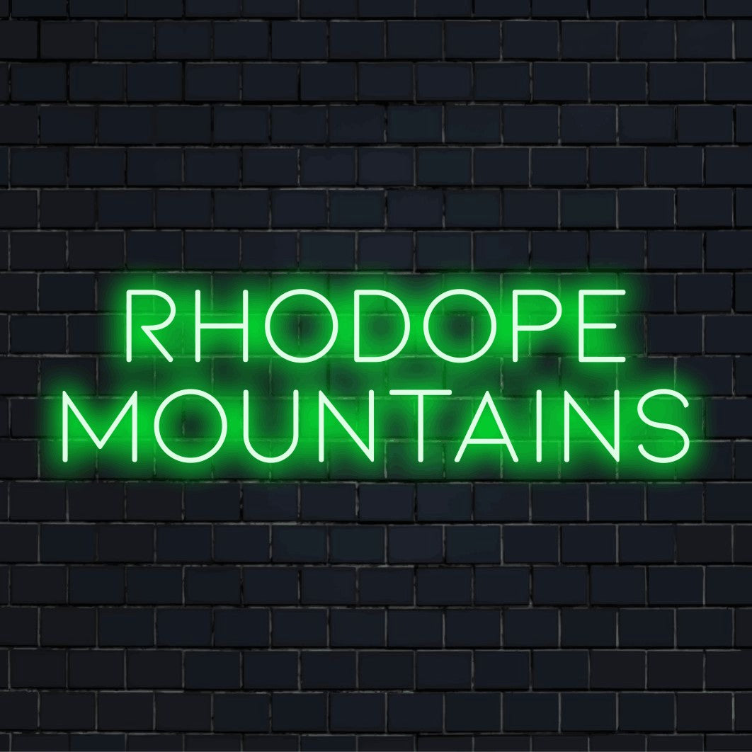 Rhodope Mountains LED Neon Sign, glowing lettering against black brick wall