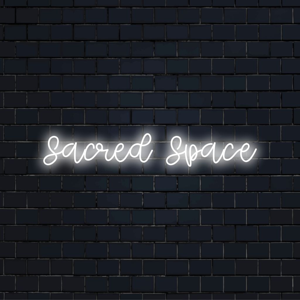 Sacred Space Neon Sign, soft neon glow against brick backdrop