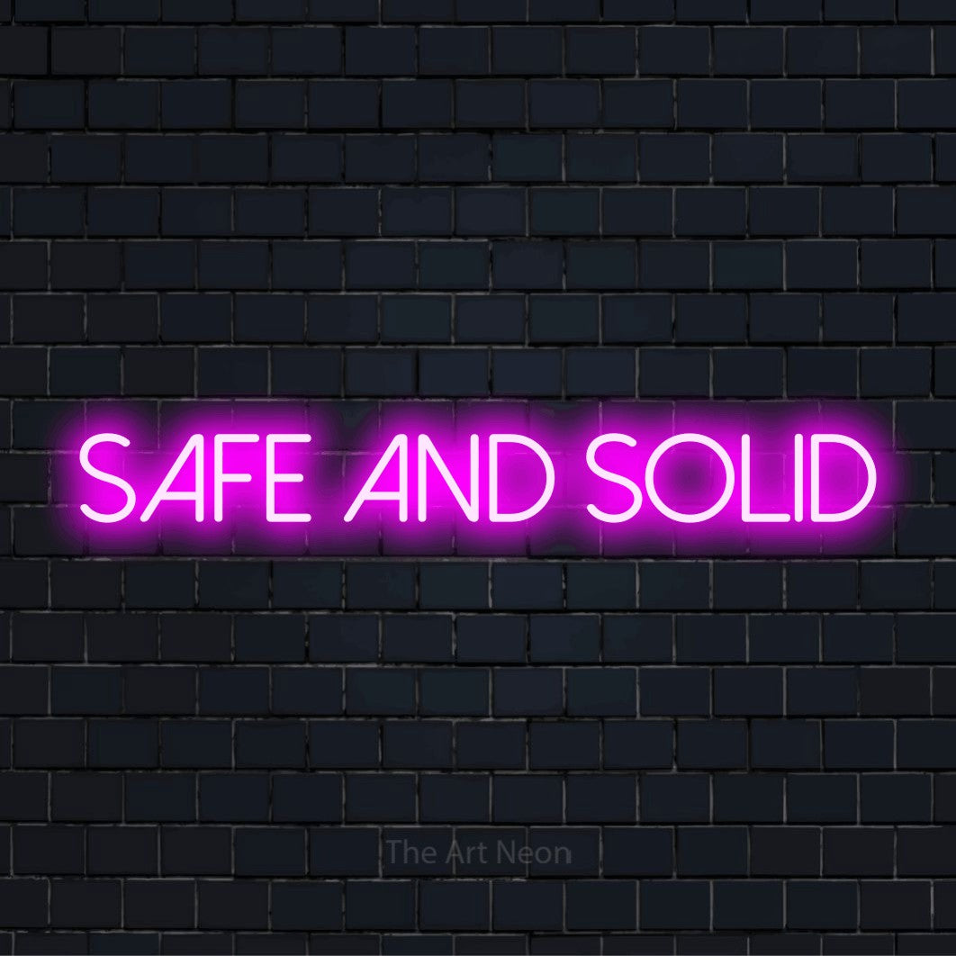 "Safe And Solid" text design with neon effect on a black brick wall