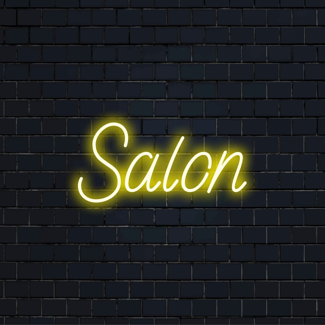 Salon Neon Sign, bright neon lettering against brick backdrop