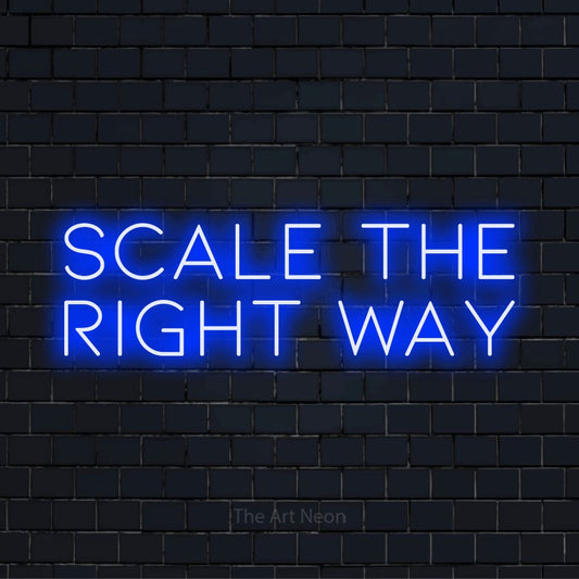"Scale The Right Way" neon text design on a black brick wall