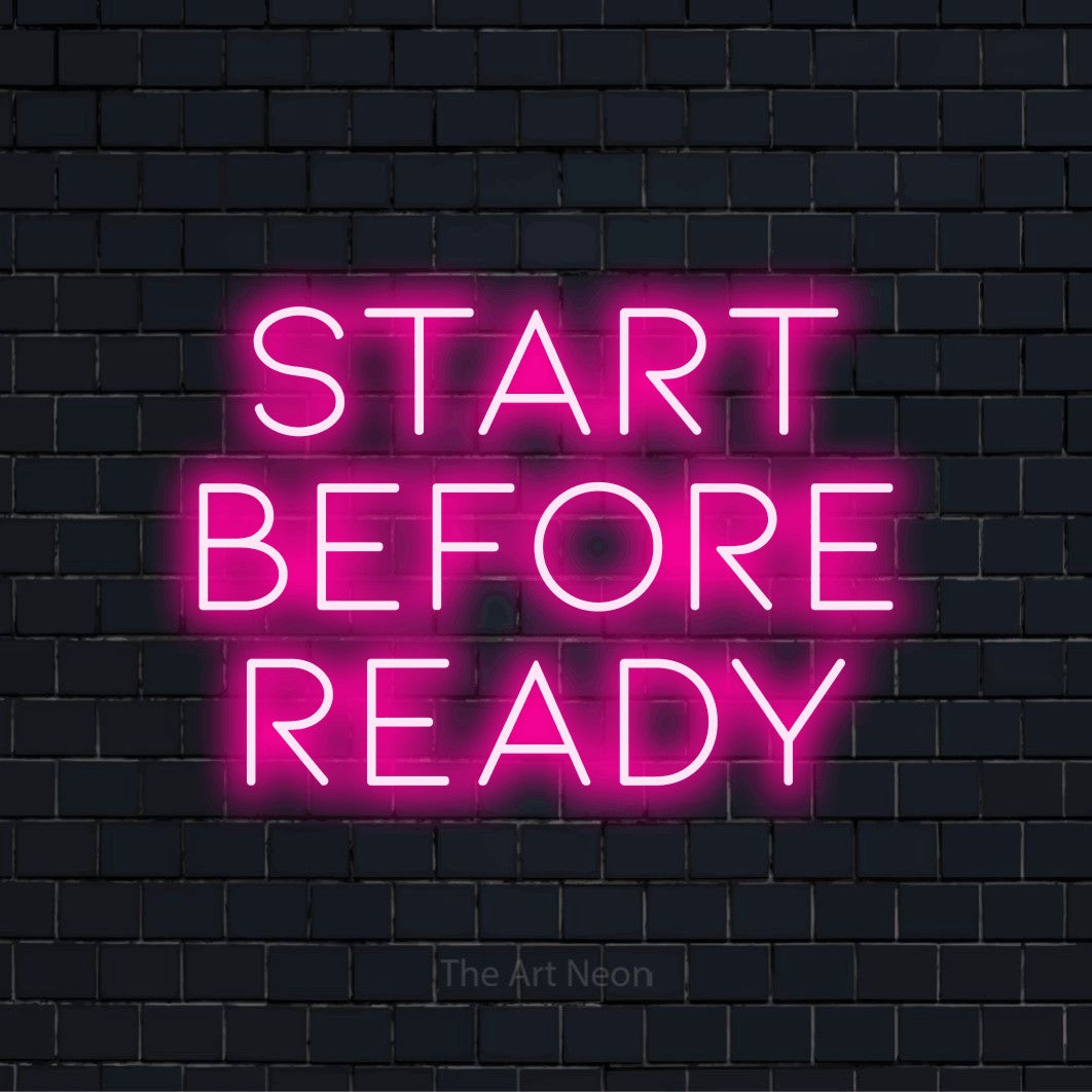 "Start Before Ready" LED neon sign on a black brick wall