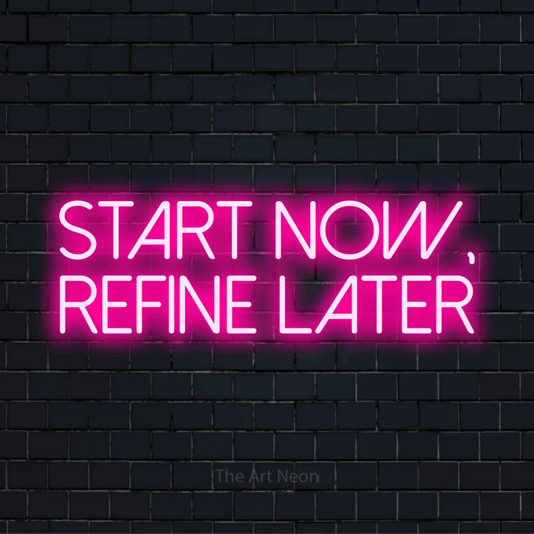 "Start Now, Refine Later" glowing LED neon sign on a black brick wall