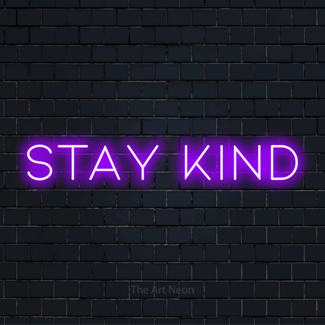 "Stay Kind" neon text design on a black brick wall