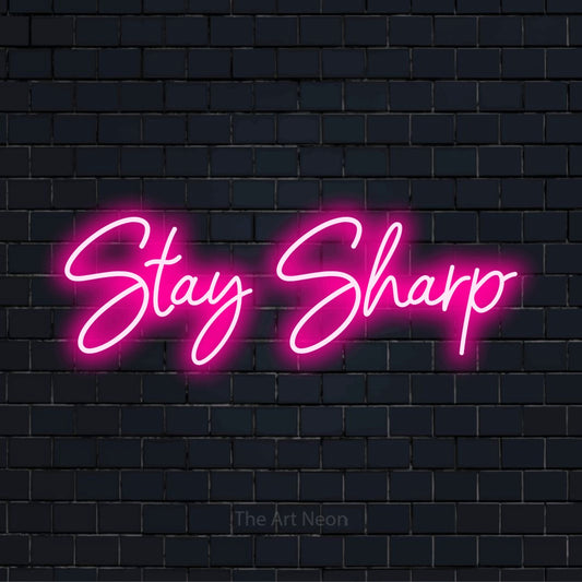 "Stay Sharp" text design with neon effect on a black brick wall