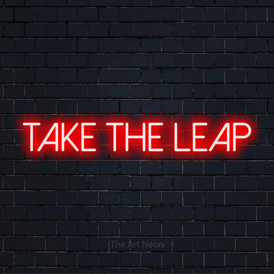 "Take The Leap" neon text design on a black brick wall