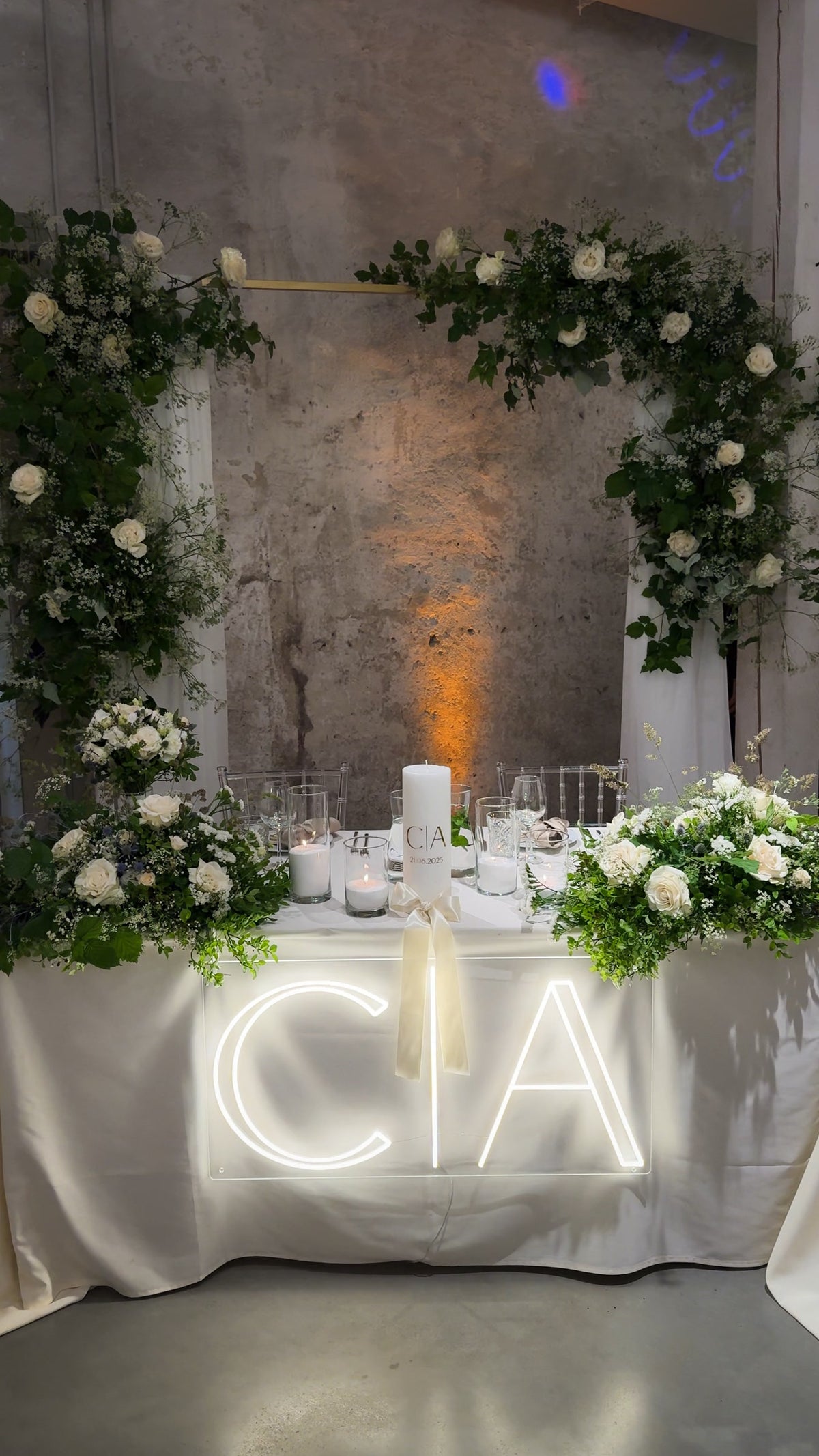 Warm-white C and A initials LED neon displayed on a table for a wedding celebration.