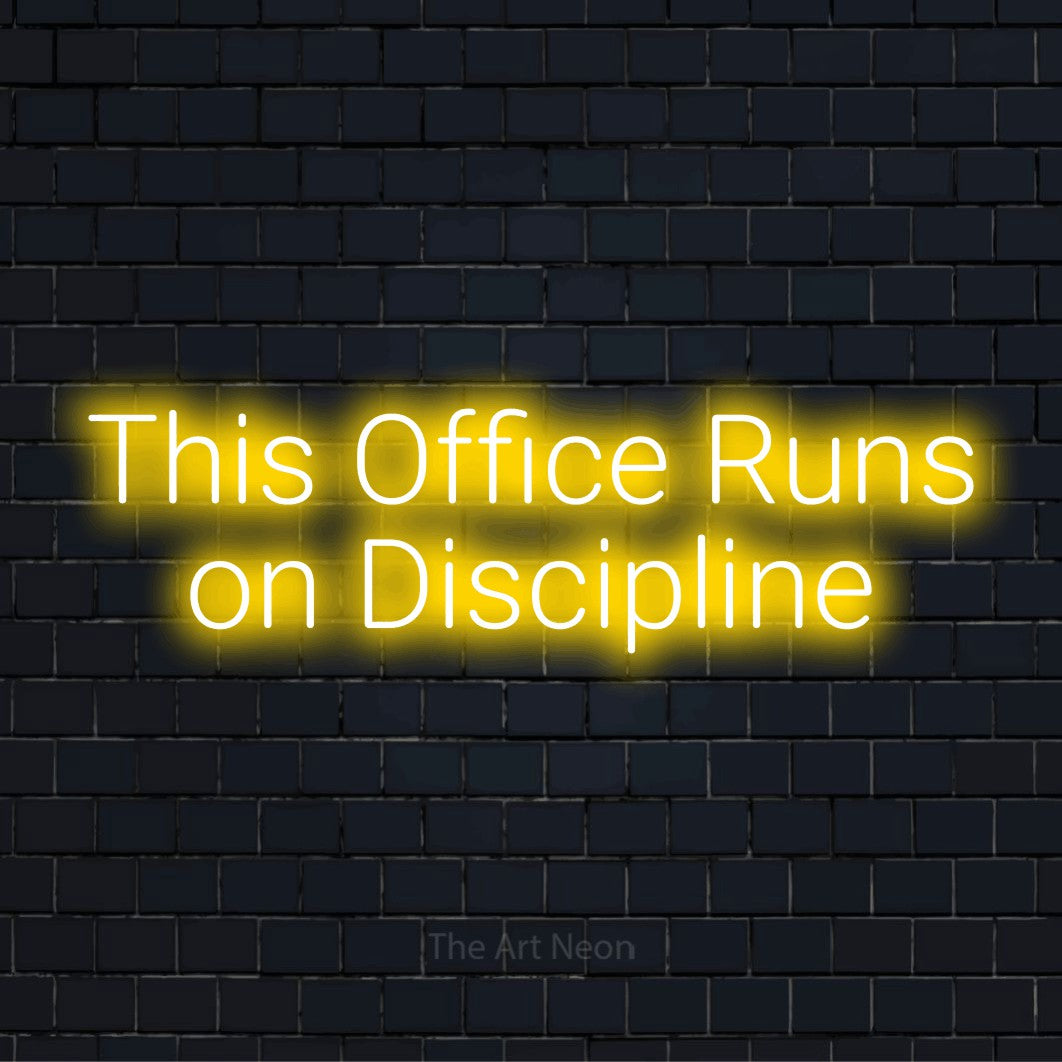 "This Office Runs On Discipline" neon text design on a black brick wall