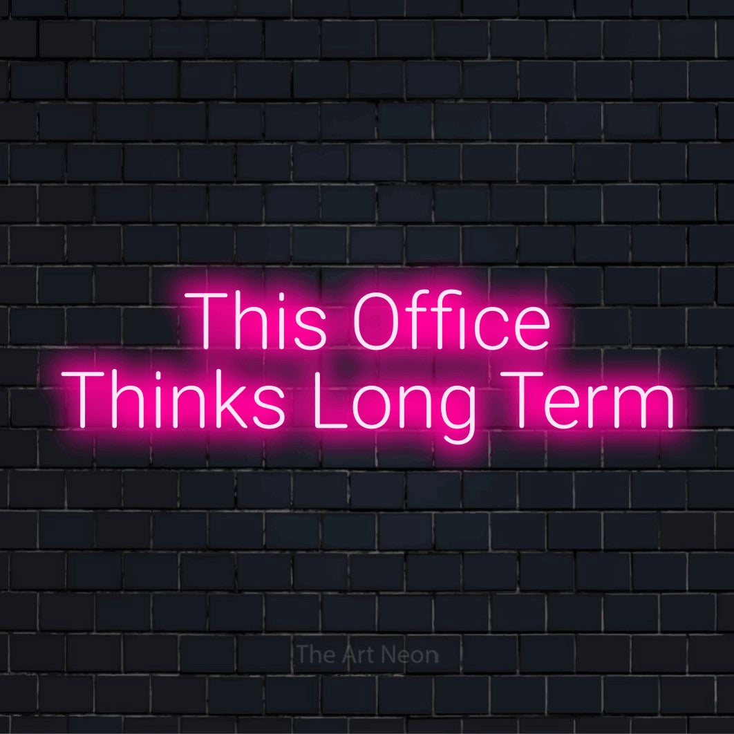 "This Office Thinks Long Term" text design with neon effect on a black brick wall
