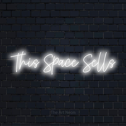 "This Space Sells" LED neon sign on a black brick wall