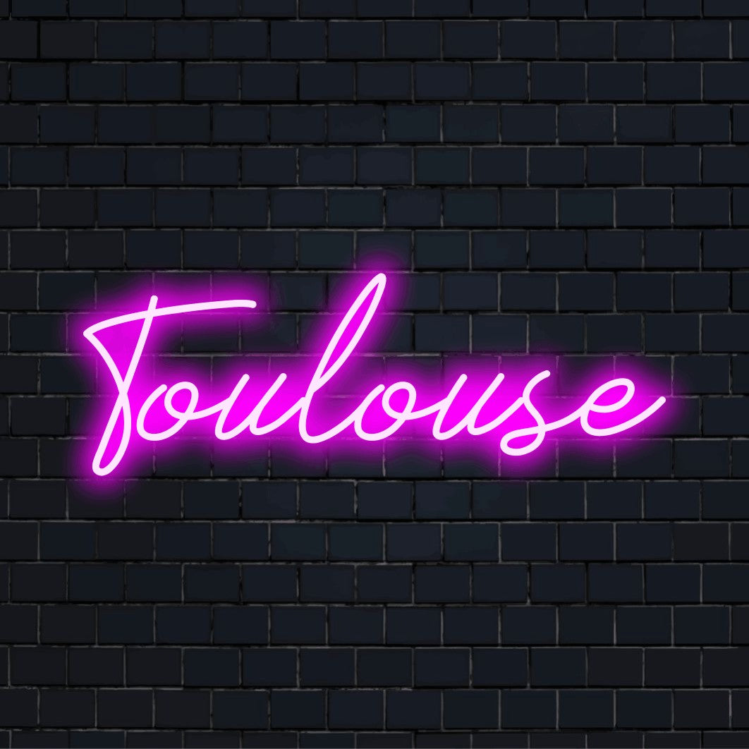 Toulouse Neon Sign, bright LED glow against brick backdrop