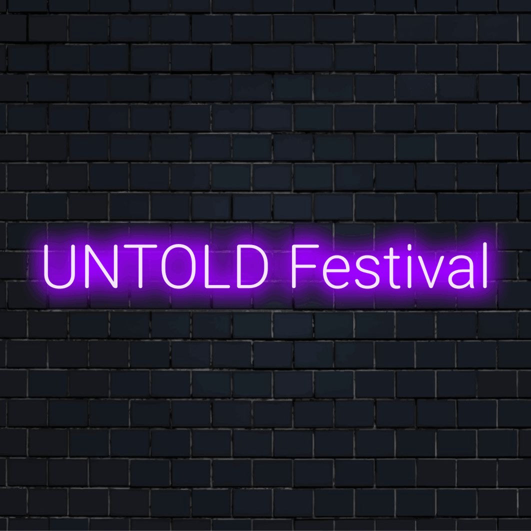 Untold Festival Neon Sign, bright LED glow on black brick background