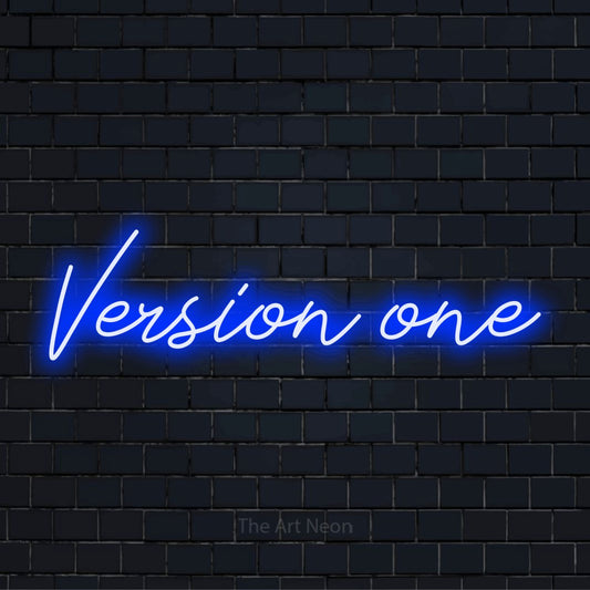 "Version One" script-style LED neon sign on a black brick wall