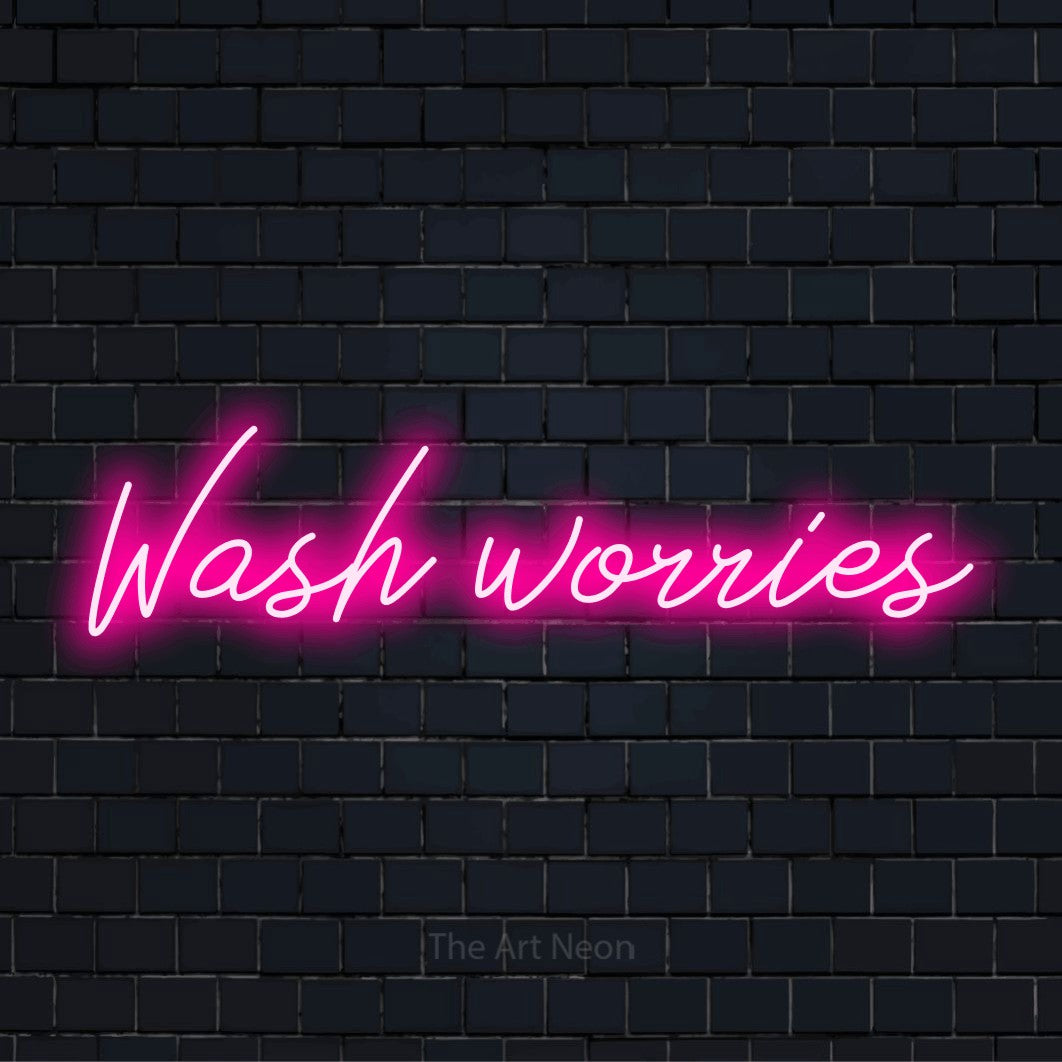 "Wash Worries" script-style LED neon sign on a black brick wall