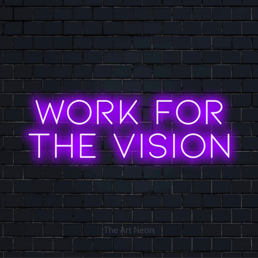 "Work For The Vision" glowing LED neon sign on a black brick wall