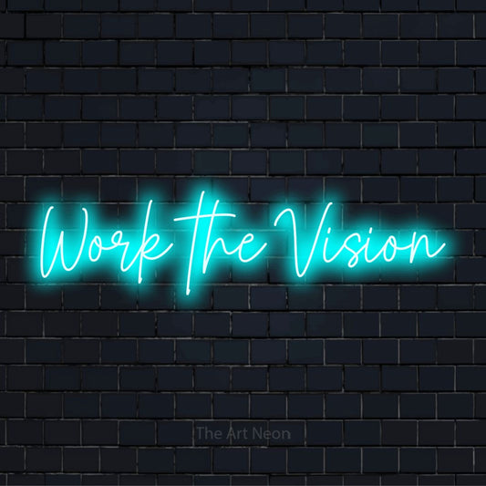 "Work The Vision" script-style LED neon sign on a black brick wall