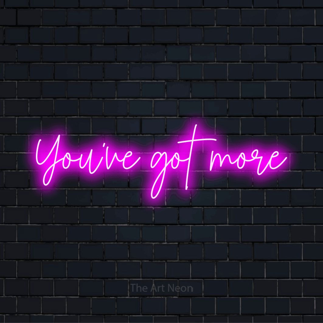 "You’ve Got More" LED neon sign on a black brick wall